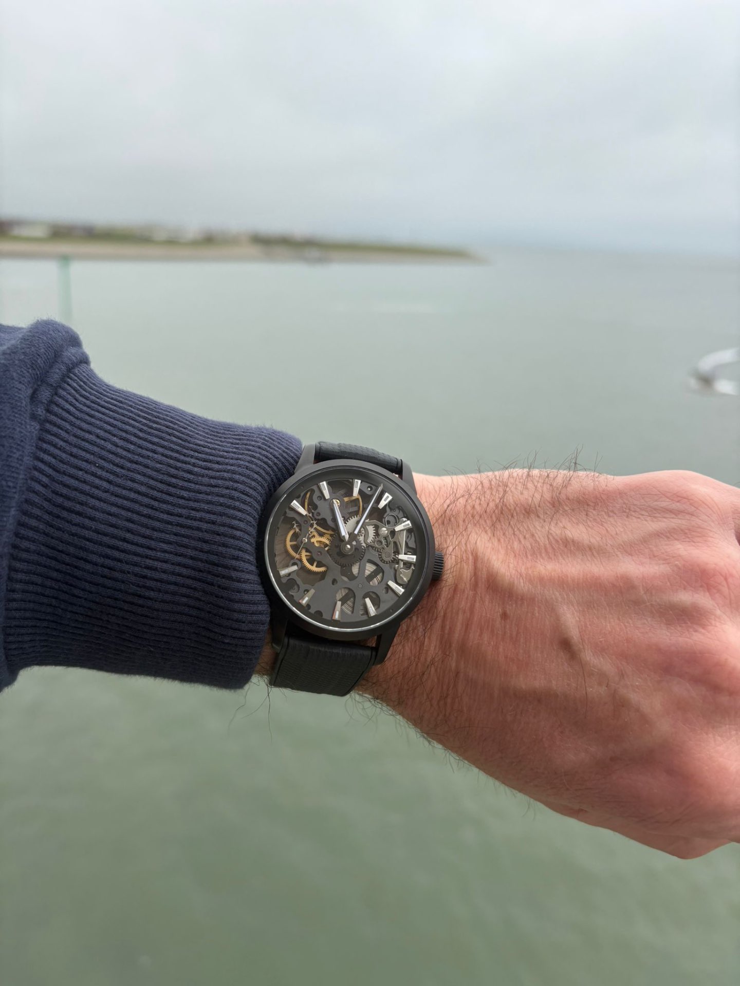 A black skeletonised Ascanbe watch worn by the water