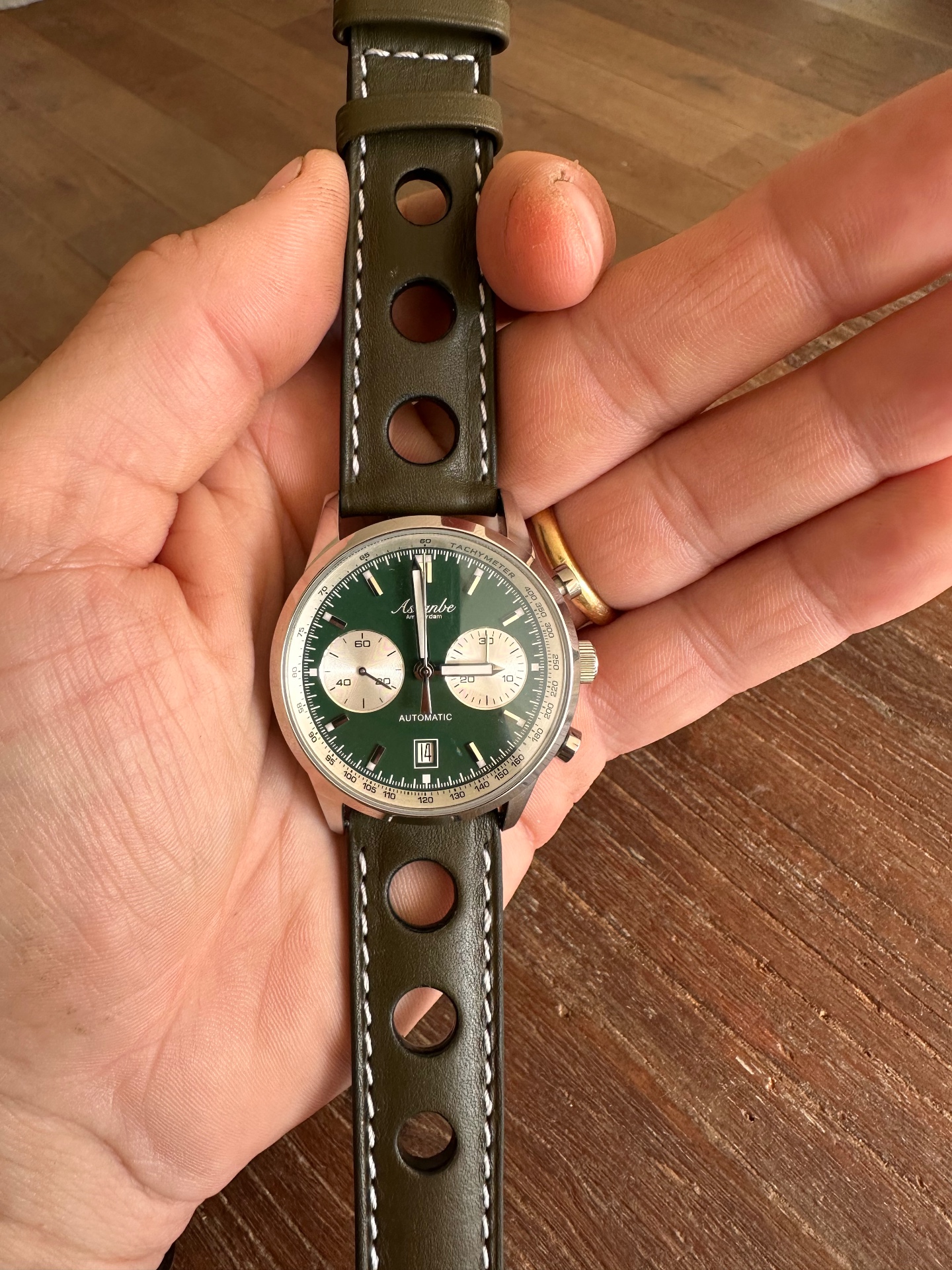A green Ascanbe chronograph with a perforated strap