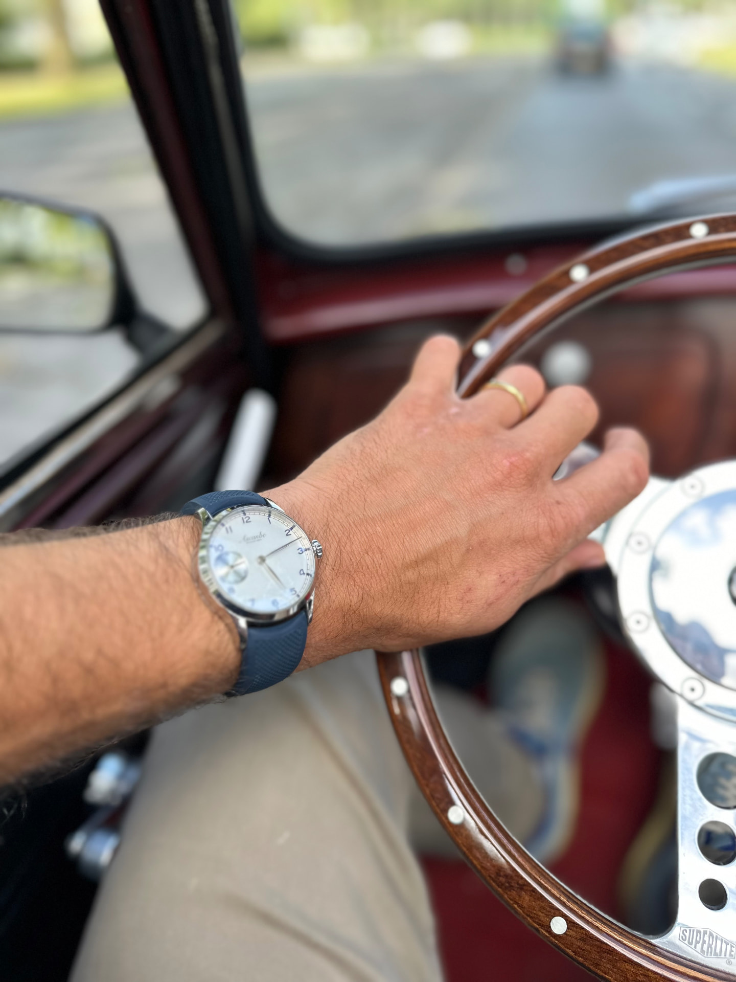 A light blue Ascanbe worn while driving a classic car